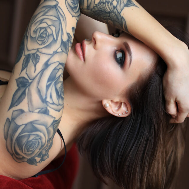 attractive young woman with tattoo posing